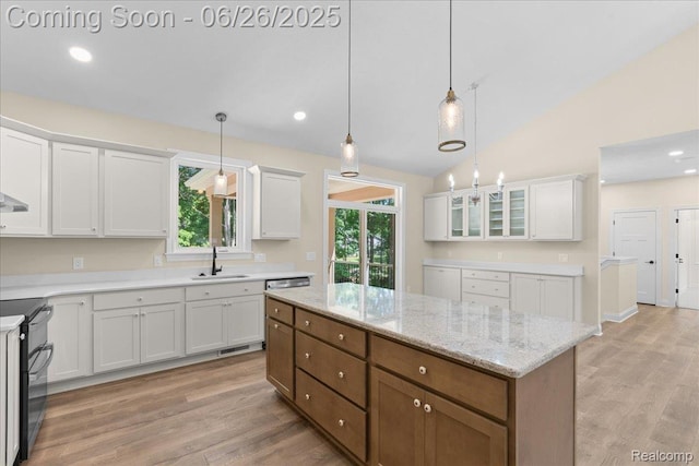 917 Chickasaw Dr, Mason, MI 48854 - kitchen featuring range with two ovens, white cabinetry, light wood-style flooring, lofted ceiling, and recessed lighting