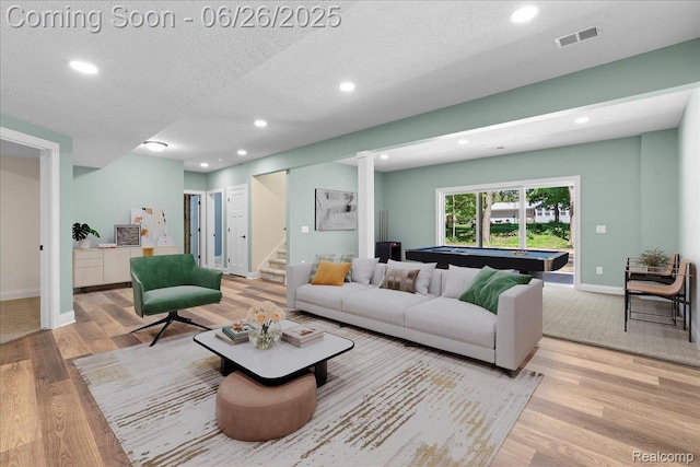 917 Chickasaw Dr, Mason, MI 48854 - living room featuring wood finished floors, stairs, billiards, recessed lighting, and a textured ceiling