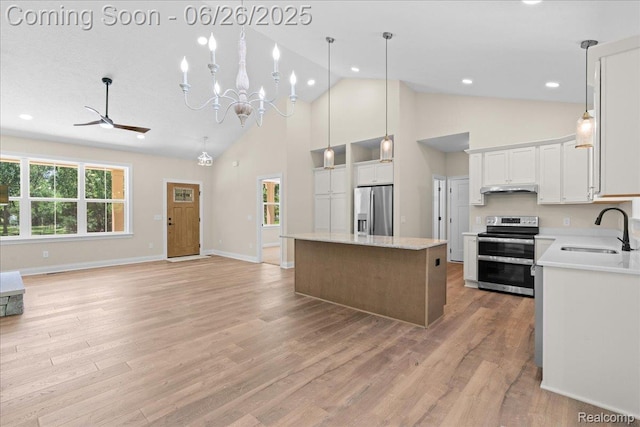 917 Chickasaw Dr, Mason, MI 48854 - kitchen featuring stainless steel appliances, high vaulted ceiling, under cabinet range hood, a center island, and open floor plan