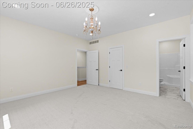 917 Chickasaw Dr, Mason, MI 48854 - unfurnished bedroom with carpet floors, a chandelier, and ensuite bathroom