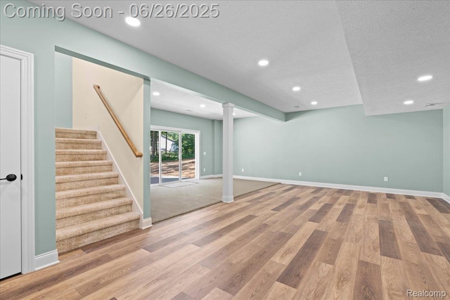 917 Chickasaw Dr, Mason, MI 48854 - basement featuring recessed lighting, wood finished floors, stairs, and a textured ceiling