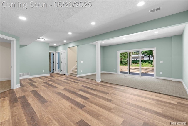 917 Chickasaw Dr, Mason, MI 48854 - basement with wood finished floors, recessed lighting, stairs, and a textured ceiling