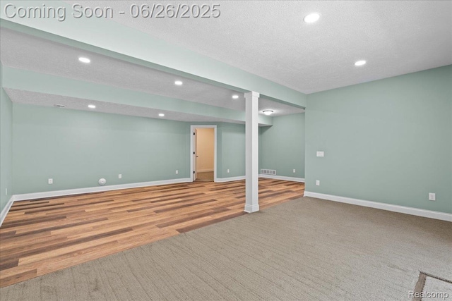 917 Chickasaw Dr, Mason, MI 48854 - finished basement featuring recessed lighting, wood finished floors, and a textured ceiling