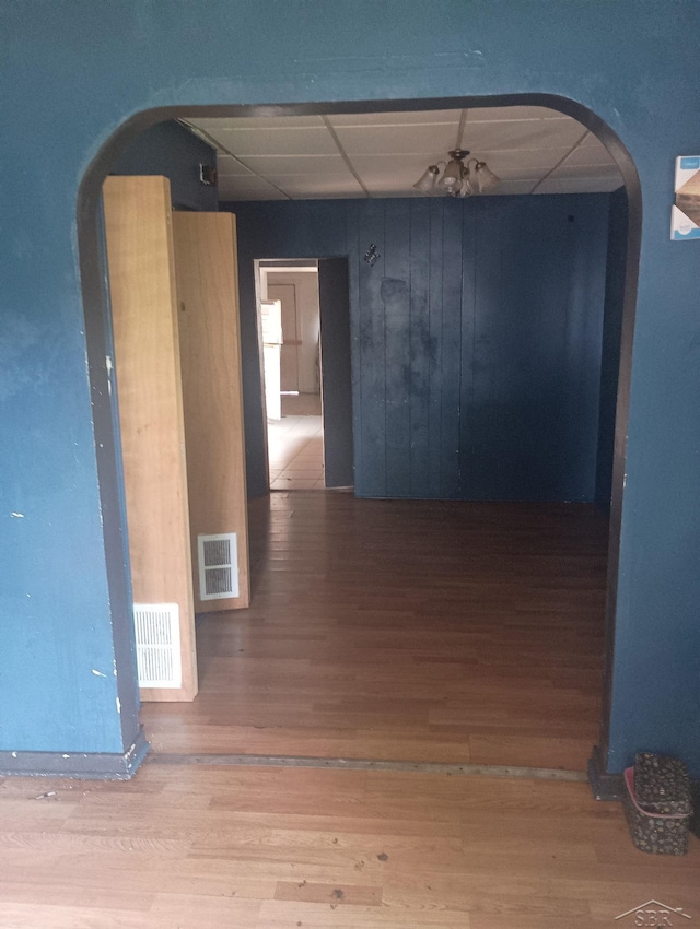1516 Greenwich St, Saginaw, MI 48602 - spare room with wood finished floors, arched walkways, and a paneled ceiling