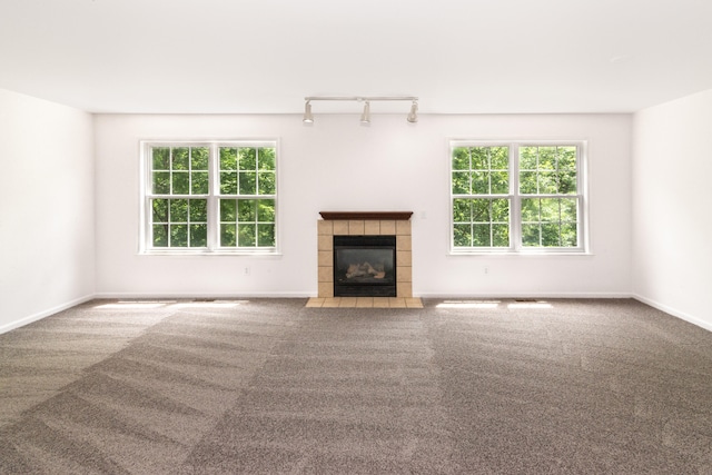 3046 Barclay Way, Ann Arbor, MI 48105 - unfurnished living room with carpet flooring, a tile fireplace, and rail lighting