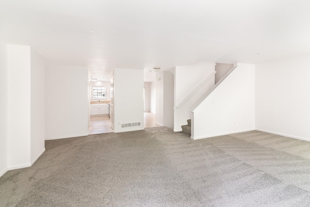 3046 Barclay Way, Ann Arbor, MI 48105 - unfurnished living room featuring carpet and stairs