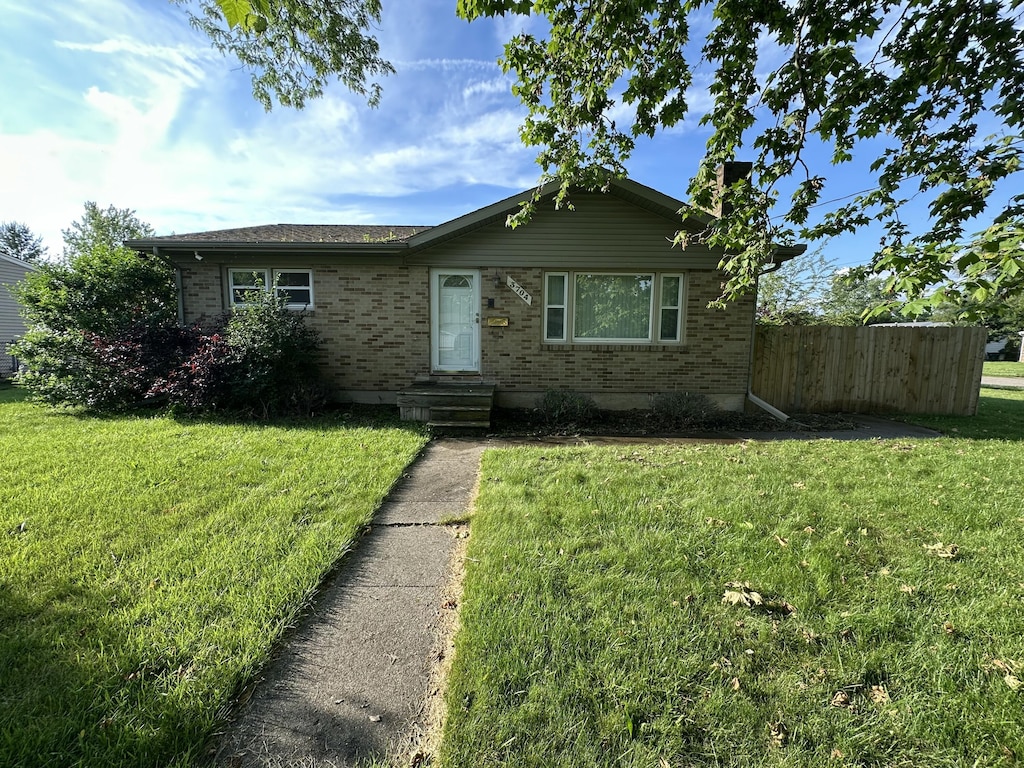 3704 Maybel St, Lansing, MI 48911 - view of front of property with brick siding and a chimney