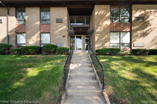 1565CHERBONEAU Cherboneau Pl Unit 52, Detroit, MI 48207 - entrance to property featuring brick siding and a yard