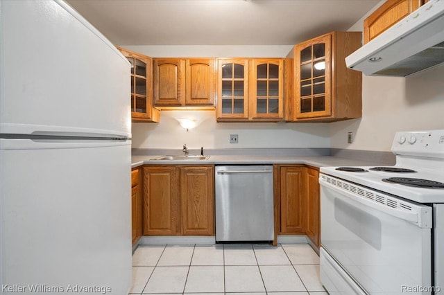 1565CHERBONEAU Cherboneau Pl Unit 52, Detroit, MI 48207 - kitchen with white appliances, exhaust hood, light tile patterned flooring, and brown cabinetry