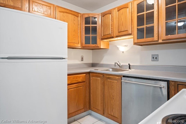 1565CHERBONEAU Cherboneau Pl Unit 52, Detroit, MI 48207 - kitchen featuring freestanding refrigerator, stainless steel dishwasher, light countertops, glass insert cabinets, and light tile patterned flooring