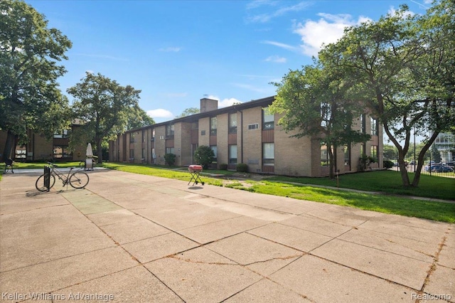 1565CHERBONEAU Cherboneau Pl Unit 52, Detroit, MI 48207 - surrounding community with a lawn
