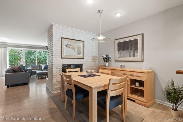 1122 Meadowglen Ct, Bloomfield Hills, MI 48304 - dining space with light wood-type flooring and a brick fireplace