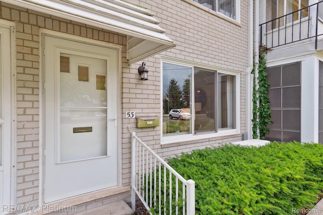 5959 Alan Dr Unit 53, Brighton, MI 48116 - doorway to property featuring brick siding