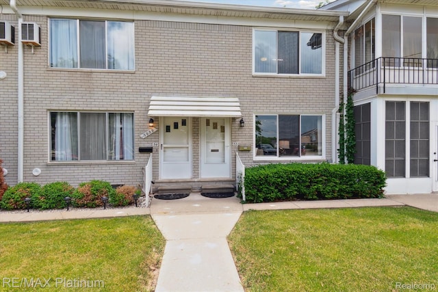 5959 Alan Dr Unit 53, Brighton, MI 48116 - view of front of home featuring brick siding and a front lawn