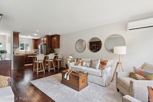 5959 Alan Dr Unit 53, Brighton, MI 48116 - living area featuring a wall unit AC, dark wood-style floors, and recessed lighting