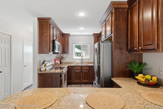 5959 Alan Dr Unit 53, Brighton, MI 48116 - kitchen with appliances with stainless steel finishes, light stone countertops, and recessed lighting