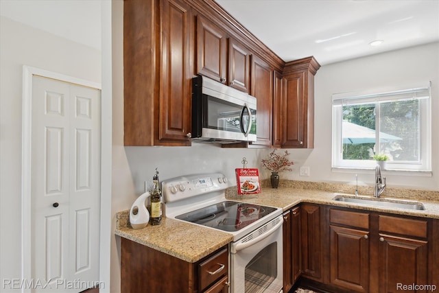 5959 Alan Dr Unit 53, Brighton, MI 48116 - kitchen featuring white range with electric cooktop, stainless steel microwave, and light stone counters