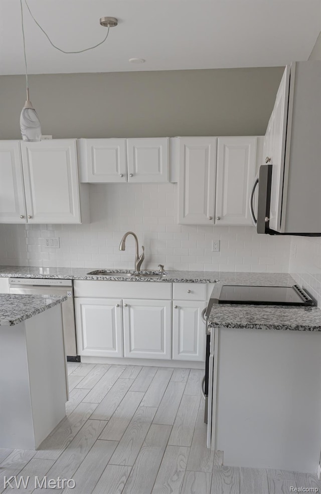 25493 Saint James, Southfield, MI 48075 - kitchen featuring white cabinetry, light stone counters, appliances with stainless steel finishes, and decorative backsplash