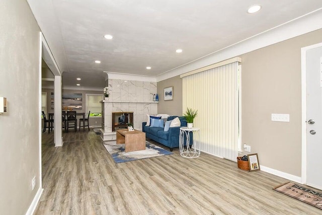 6604 E H Ave, Kalamazoo, MI 49048 - living area featuring wood finished floors, recessed lighting, ornamental molding, and a tiled fireplace