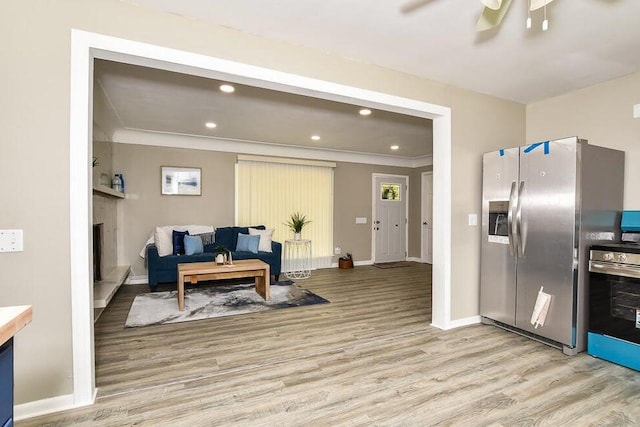 6604 E H Ave, Kalamazoo, MI 49048 - kitchen with light wood-type flooring, stainless steel fridge with ice dispenser, recessed lighting, ceiling fan, and crown molding