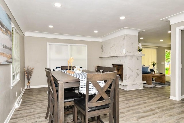 6604 E H Ave, Kalamazoo, MI 49048 - dining area with light wood-style floors, recessed lighting, a high end fireplace, and ornamental molding