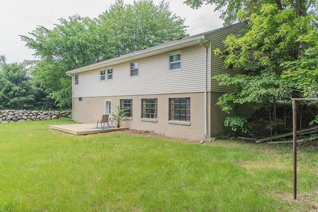 6604 E H Ave, Kalamazoo, MI 49048 - rear view of property with a deck and a lawn