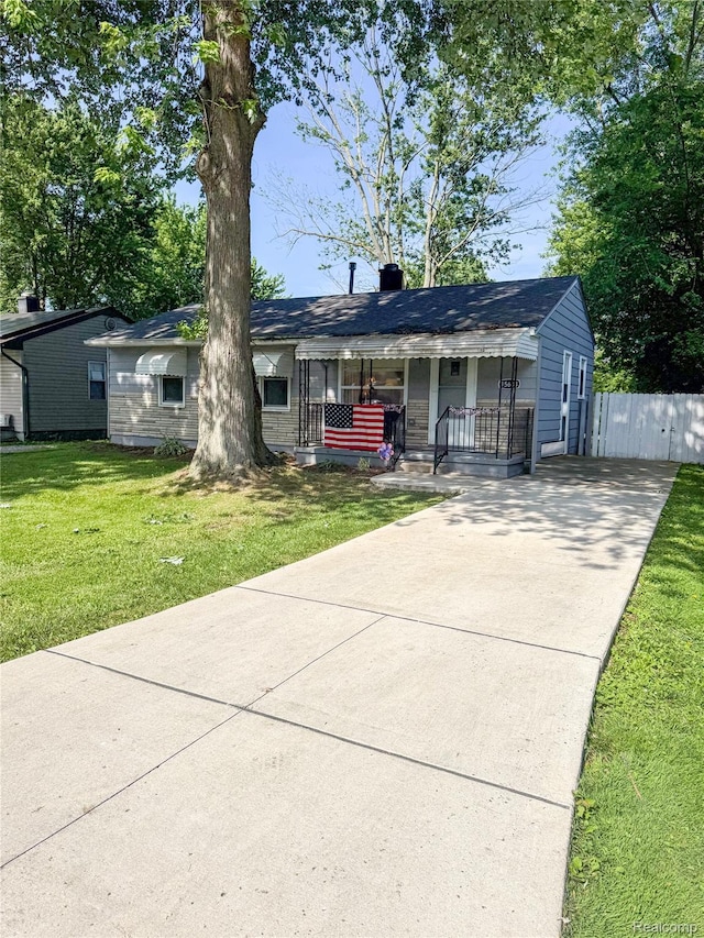 15684 Mcguire St, Taylor, MI 48180 - view of front of home featuring concrete driveway, covered porch, and a chimney