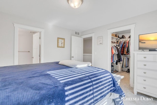 605 Bedford Falls Dr, Sparta, MI 49345 - bedroom with a walk in closet, light colored carpet, and a closet