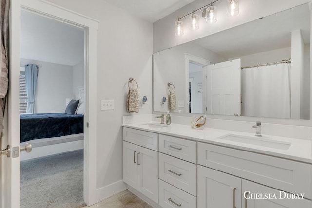 605 Bedford Falls Dr, Sparta, MI 49345 - ensuite bathroom with double vanity and baseboards