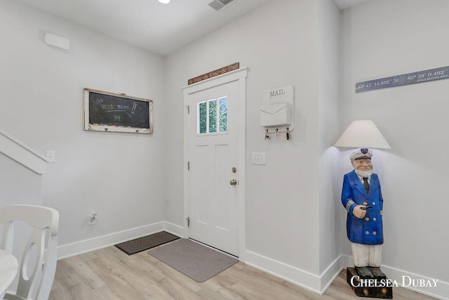 605 Bedford Falls Dr, Sparta, MI 49345 - foyer with wood finished floors and baseboards