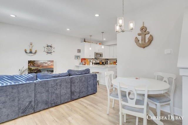 605 Bedford Falls Dr, Sparta, MI 49345 - living area featuring light wood-type flooring, a chandelier, and recessed lighting
