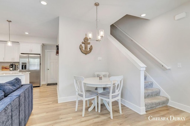 605 Bedford Falls Dr, Sparta, MI 49345 - dining area with light wood-type flooring, stairs, a chandelier, and recessed lighting