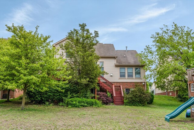 2385 Yasmin Dr, Michigan, MI 48382 - rear view of house with a playground, brick siding, stairs, a lawn, and a shingled roof