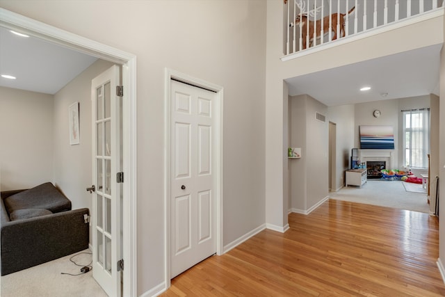 2385 Yasmin Dr, Michigan, MI 48382 - hallway featuring light wood-style floors, a high ceiling, and recessed lighting