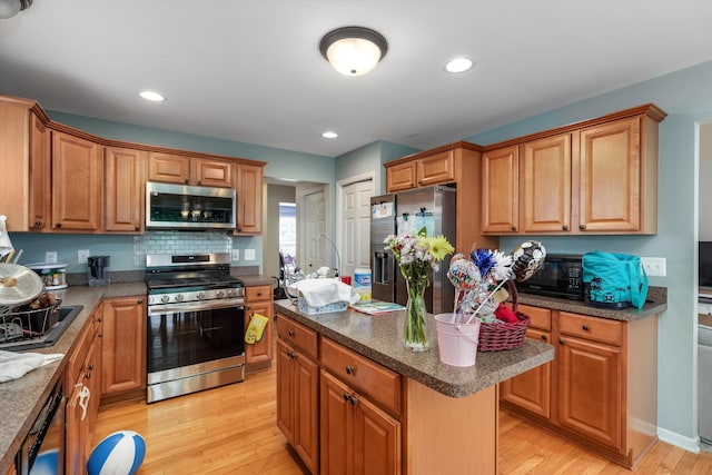 2385 Yasmin Dr, Michigan, MI 48382 - kitchen with appliances with stainless steel finishes, light wood-style floors, a center island, brown cabinets, and recessed lighting