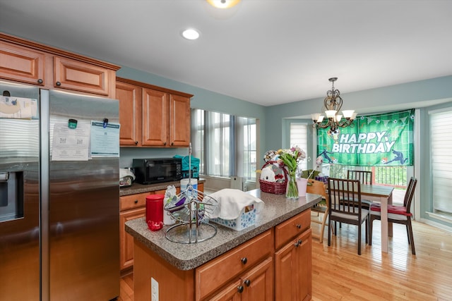 2385 Yasmin Dr, Michigan, MI 48382 - kitchen featuring stainless steel fridge, a chandelier, brown cabinetry, light wood-type flooring, and a kitchen island