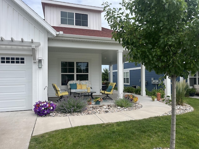 686 Terrace Point Dr Unit 22, Muskegon, MI 49440 - covered porch with an attached garage and outdoor lounge area