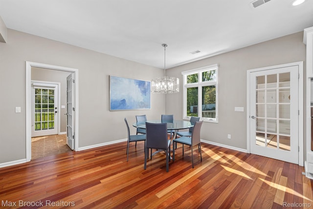 9239 Silverside, South Lyon, MI 48178 - dining area with wood finished floors and a chandelier