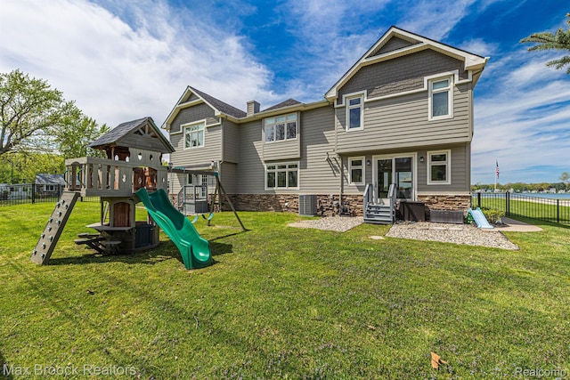 9239 Silverside, South Lyon, MI 48178 - rear view of property featuring a playground, stone siding, and entry steps
