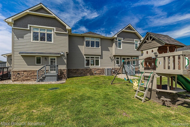 9239 Silverside, South Lyon, MI 48178 - rear view of house featuring a playground, stone siding, and a yard