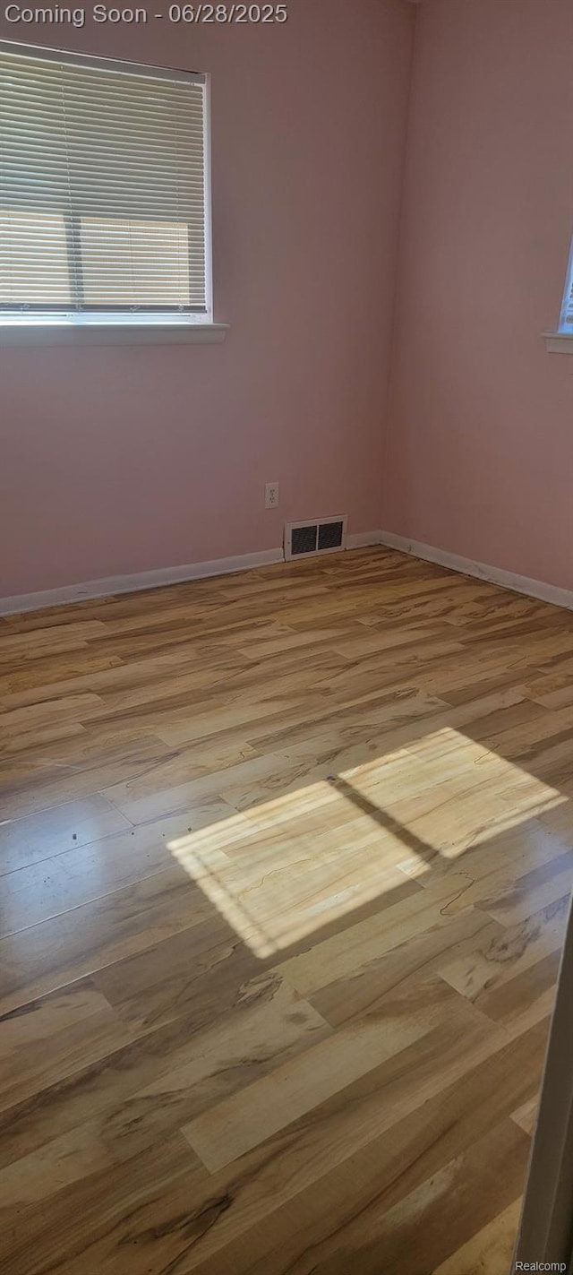 28406 Stuart Ave, Southfield, MI 48076 - unfurnished room with wood finished floors and plenty of natural light
