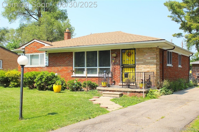 1902 Marlowe Dr, Flint, MI 48504 - view of front facade with a chimney, a front lawn, brick siding, covered porch, and a shingled roof
