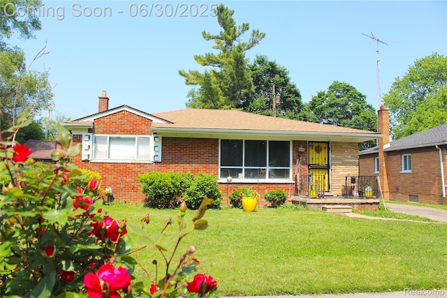 1902 Marlowe Dr, Flint, MI 48504 - view of front facade featuring a front yard, brick siding, and a chimney