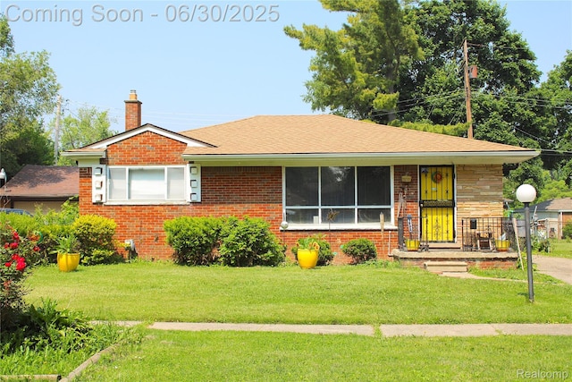 1902 Marlowe Dr, Flint, MI 48504 - bungalow featuring a chimney, a front yard, and brick siding