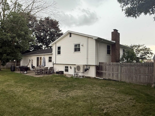 808 Stevens Dr, Owosso, MI 48867 - back of house with a chimney and a patio area