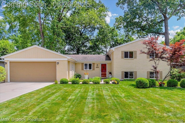 2425 Avondale St W, Sylvan Lake, MI 48320 - split level home with a garage, brick siding, concrete driveway, and a front lawn