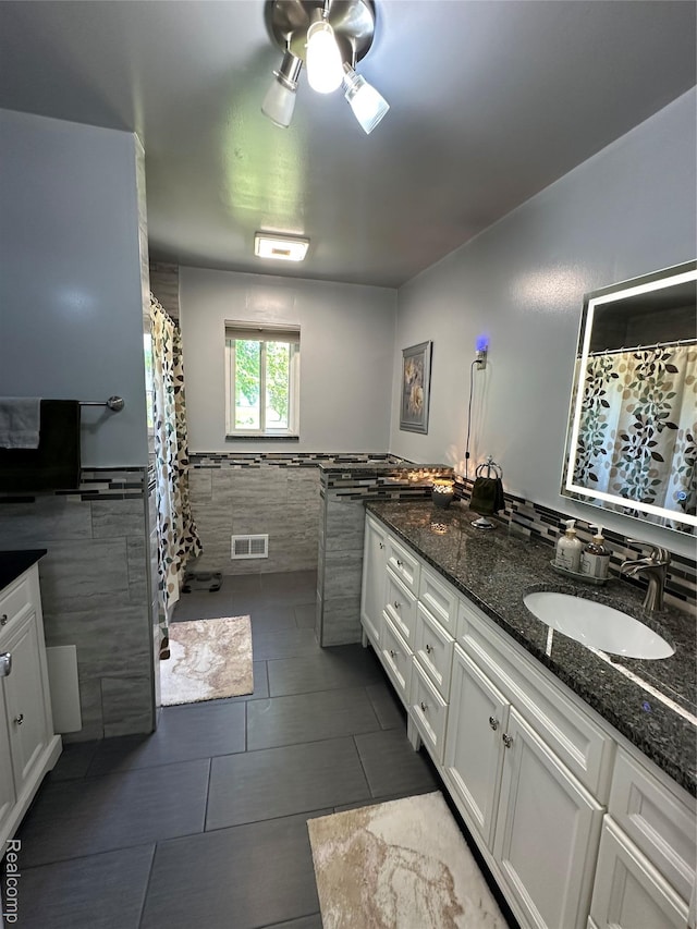 32302 Ryan Rd, Warren, MI 48092 - full bathroom featuring tile walls, vanity, a wainscoted wall, tile patterned flooring, and ceiling fan