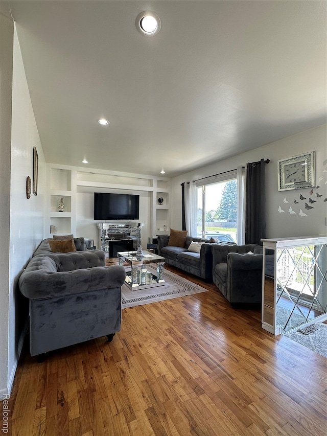 32302 Ryan Rd, Warren, MI 48092 - living area featuring wood finished floors, built in features, recessed lighting, and a fireplace