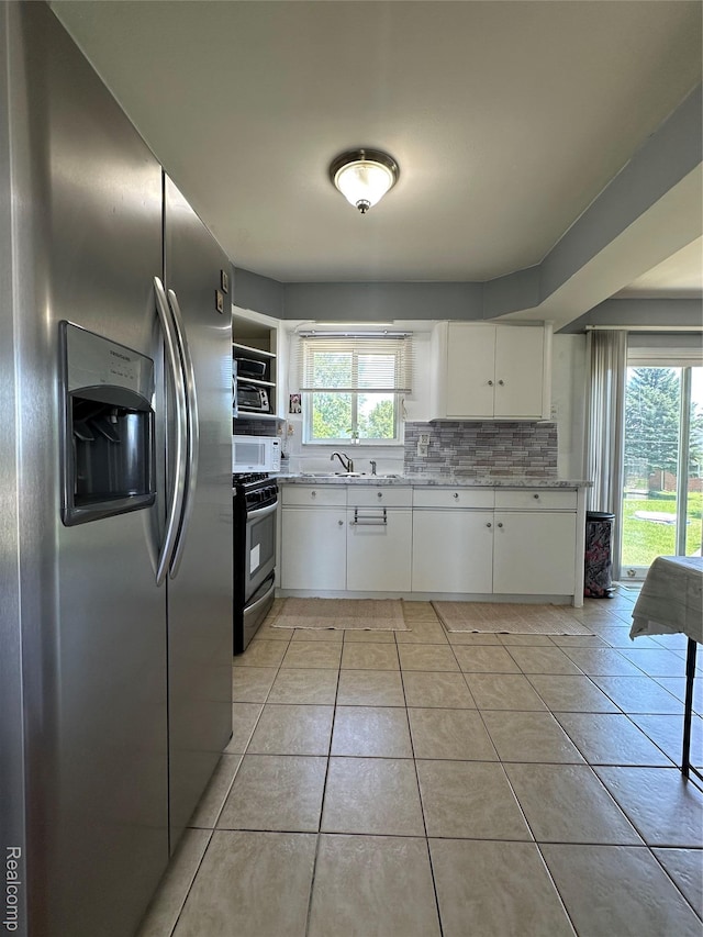 32302 Ryan Rd, Warren, MI 48092 - kitchen featuring stainless steel appliances, backsplash, white cabinets, open shelves, and light stone countertops