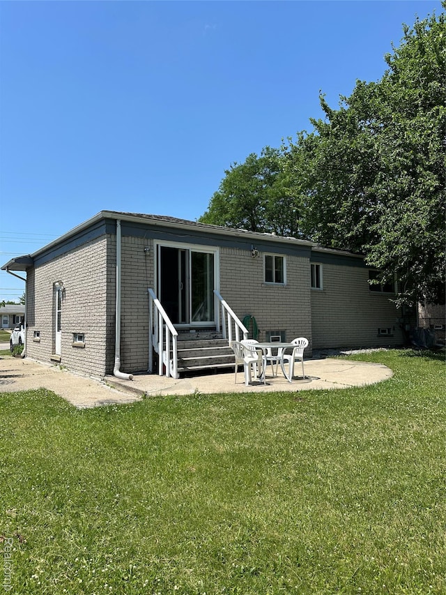 32302 Ryan Rd, Warren, MI 48092 - back of property featuring entry steps, brick siding, a patio, and a yard